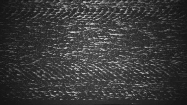Abstract visual noise flickering on screen with digital distortion effect and vintage analog texture overlay.