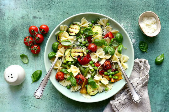 Traditional italian pasta primavera with spring vegetables. Top view with copy space.