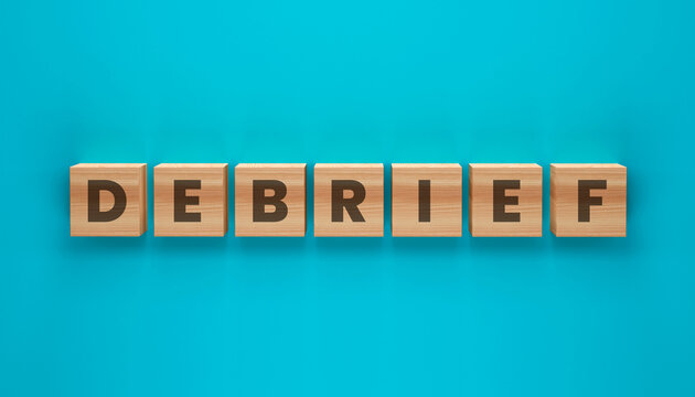 Debriefing on Blue Background: The word 'DEBRIEF' is spelled out using wooden letter blocks against a vibrant blue backdrop, creating a visually engaging concept.