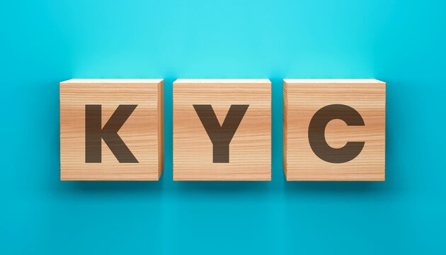 KYC Blocks: Three wooden blocks, arranged horizontally, prominently display the letters KYC, symbolizing the essential Know Your Customer process.