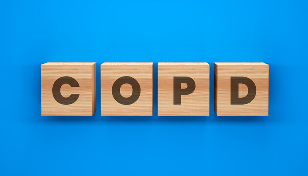 COPD Message on Blocks: A conceptual representation features the acronym COPD spelled out in wooden blocks, set against a calm blue backdrop, symbolizes chronic lung condition. 