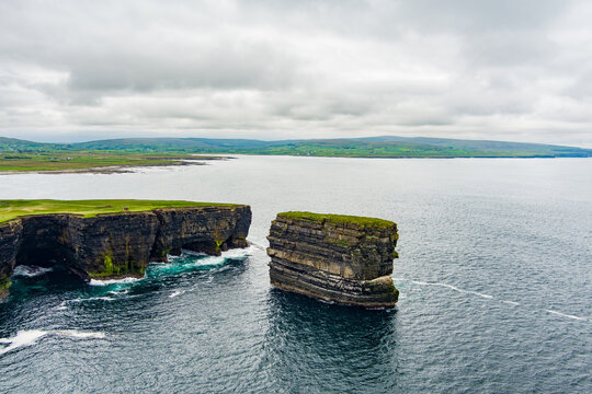Aerial view of Dun Briste sea stack at Downpatrick Head, County Mayo, Ireland. Spectacular layered cliffs and Atlantic waves on the Wild Atlantic Way.