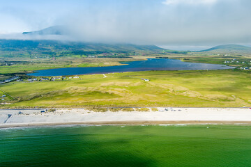 Naklejka premium Aerial view of Keel Beach on Achill Island, County Mayo, Ireland. Turquoise Atlantic water, white sand and low cloud along the Wild Atlantic Way.