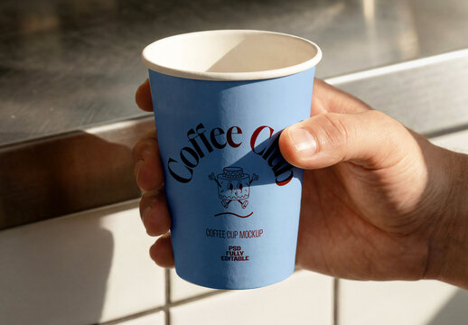 Hand Holding Paper Coffee Cup Mockup