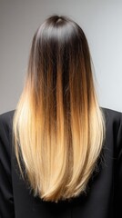Naklejka premium Woman showing trendy ombre balayage hairstyle from brunette to blonde with long straight hair, creating a modern and stylish hair color look for beauty and fashion concepts