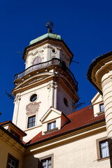Fototapeta premium Astronomical Tower of the Klementinum in Prague with Atlant statue holding heavens, Czech Republic, clear blue sky, sunny day
