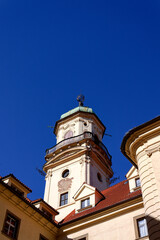Obraz premium Astronomical Tower of the Klementinum in Prague with Atlant statue holding heavens, Czech Republic, clear blue sky, sunny day