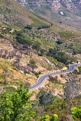 Obraz premium Cars, mountain and road with landscape in nature for travel adventure, roadtrip and rocky terrain. Vehicles, hill and highway in natural environment for scenic route, getaway journey and vegetation