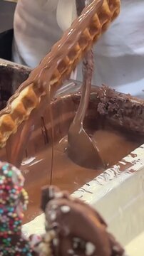 Kurtos chimney cake preparation Hungarian Czech sweet dough rolled over spit traditional baked dessert street food