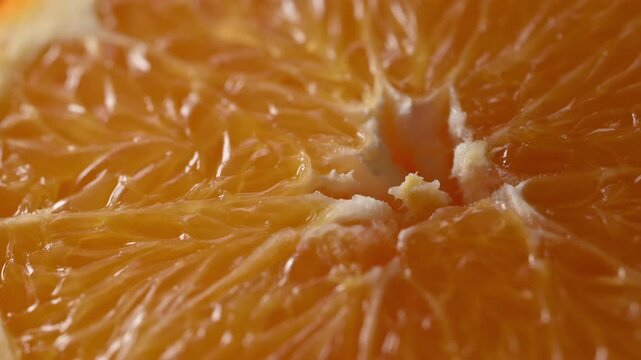Orange pulp extreme macro with sliding light revealing juicy citrus texture