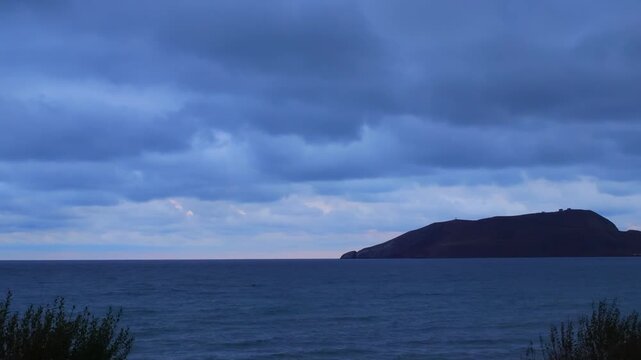 Evening to Night Sea Timelapse with Dark Clouds and Waves. Coastal Sunset to Night Timelapse with Windy Ocean and Clouds. Dark Ocean Timelapse with Storm Clouds and Night Transition. Copy space. Backg