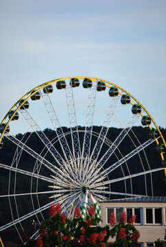 Stuttgart, Germany &ndash; May 2, 2026: A lively beer festival fills the Cannstatter Wasen fairground with crowds enjoying numerous attractions, including a Ferris wheel, colorful carousels, and extreme 