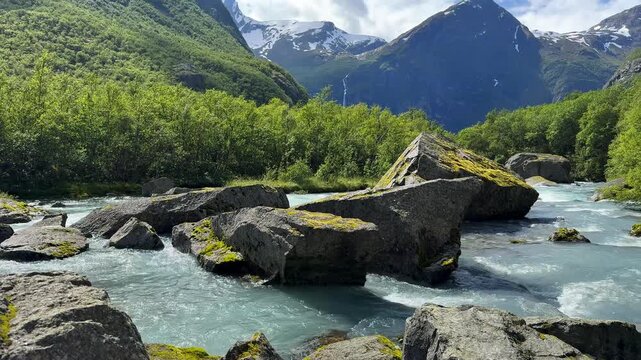The river flows through huge rocks among the mountains