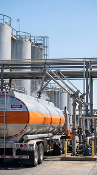 Industrial fuel storage facility with tanker truck transferring flammable liquid