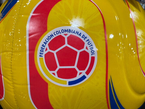 Bogot&aacute;, Colombia. May 12, 2026. Close-up of the Federaci&oacute;n Colombiana de F&uacute;tbol crest on a glossy yellow soccer ball with red accents.