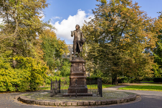 Monument to Immanuel Kant in a city park surrounded by autumn trees and walking paths. Kaliningrad, Russia. October 10, 2025