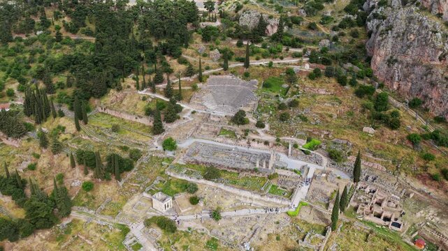 Aerial footage moving over the ancient theatre and temple of Apollo at the archaeological site of Delphi, a Unesco world heritage site located on the slopes of mount Parnassus in Greece