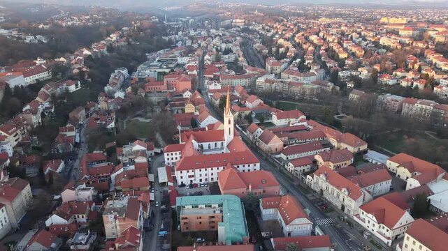 Aerial view of Zagreb Cathedral and the historic Kaptol district. Cinematic drone shot of the Gothic spires and the medieval walls of the Cathedral of the Assumption of the Blessed Virgin Mary in Croa