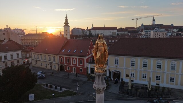 Aerial view of Zagreb Cathedral and the historic Kaptol district. Cinematic drone shot of the Gothic spires and the medieval walls of the Cathedral of the Assumption of the Blessed Virgin Mary in Croa