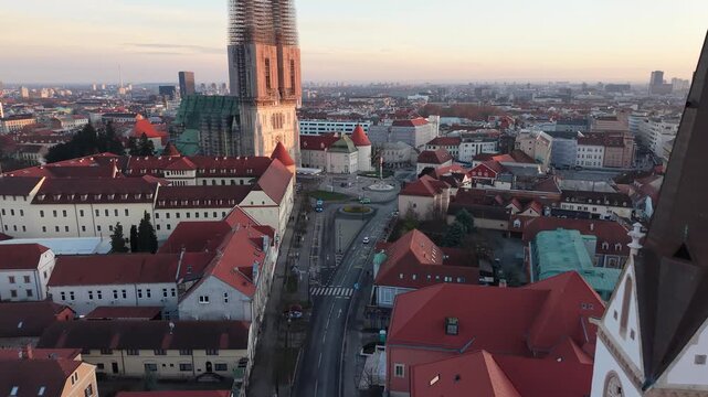 Aerial view of Zagreb Cathedral and the historic Kaptol district. Cinematic drone shot of the Gothic spires and the medieval walls of the Cathedral of the Assumption of the Blessed Virgin Mary in Croa