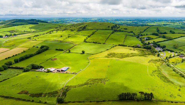 Patchwork fields spread across County Meath, Ireland, under heavy cloud. A peaceful Boyne Valley farming landscape of hedgerows, pasture and rural roads.