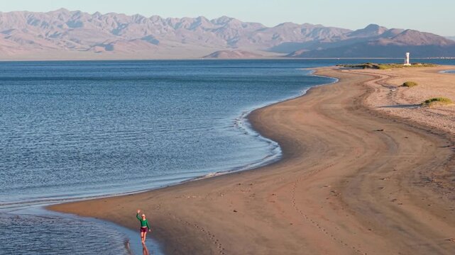 Watch aerial views of Bahia de Los Angeles in Baja California Mexico as the sun sets over water and sand in the late afternoon light.