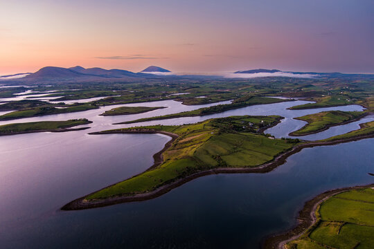Aerial sunset view over Clew Bay near Westport, County Mayo, Ireland. Scenic Atlantic bay with drumlin islands and mountain silhouettes on the Wild Atlantic Way.