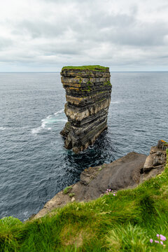 Dun Briste sea stack at Downpatrick Head, County Mayo, Ireland. Dramatic Atlantic cliffs, wildflowers and layered rock on the Wild Atlantic Way.