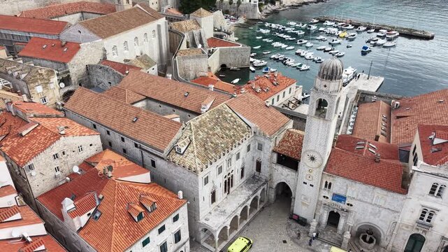 Aerial view of Dubrovnik Old Town and its medieval city walls. Cinematic shot of the UNESCO World Heritage site featuring limestone streets and terracotta roofs in Croatia.