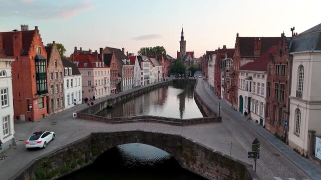 Aerial Ascent Over Spiegelrei Canal and Poortersloge at Sunset in Bruges Belgium