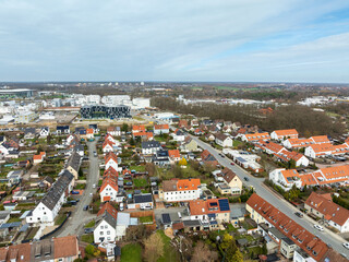 Fototapeta premium Aerial view of Stadtmitte district in Wolfsburg with residential area and industrial skyline