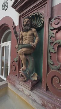 Close-up of Neptune sculpture with trident and serpent on ornate Renaissance fountain in Basel, Switzerland. Vertical video