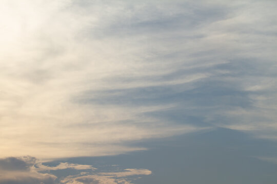 Peaceful blue sky filled with layered white clouds and soft daylight tones, creating a clean natural atmosphere ideal for backgrounds and outdoor concepts.
