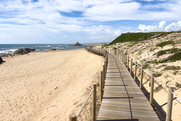 Fototapeta premium Wooden Boardwalk leading to Praia de Miramar Beach in Portugal