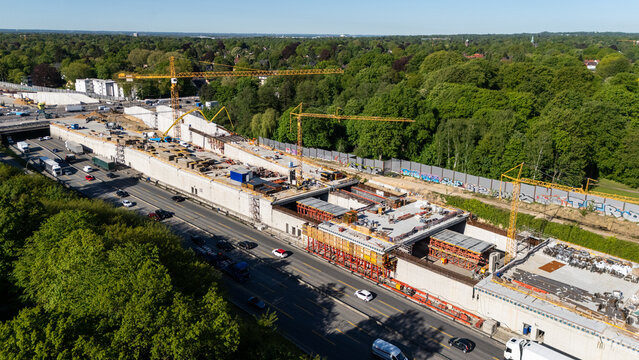 Aerial view of the Bahrenfeld motorway tunnel construction site with yellow cranes and concrete structures along the A7 highway in Hamburg, Hamburg, Germany.