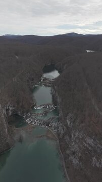 Aerial view of the stunning waterfalls and turquoise lakes in Plitvice Lakes National Park. Cinematic drone shot of the UNESCO World Heritage site in Croatia