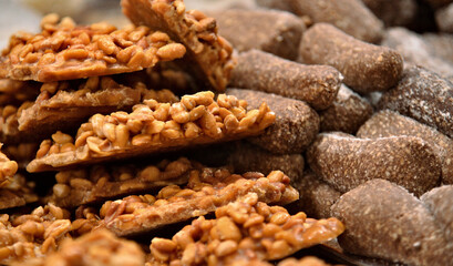 Fototapeta premium Pé de moleque and Cajuzinho are traditional Brazilian sweets served at Festa Junina and São João celebrations. They are traditional Brazilian sweets made with peanuts.