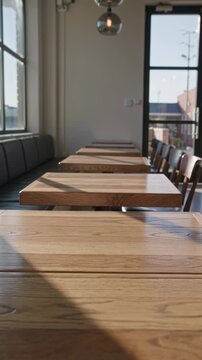 Empty cafe interior with natural sunlight through large windows, cozy coffee shop atmosphere 4K