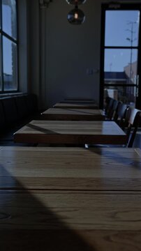 Empty cafe at night with moody lighting, dark cozy coffee shop interior, no people, urban nightlife atmosphere 4K