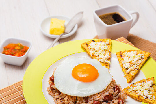Close up of Colombian Calentado Breakfast with Fried Egg, Arepa, Hogao and Tinto Coffee