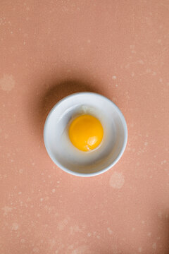 egg yolk removed from the shell and placed in a white bowl