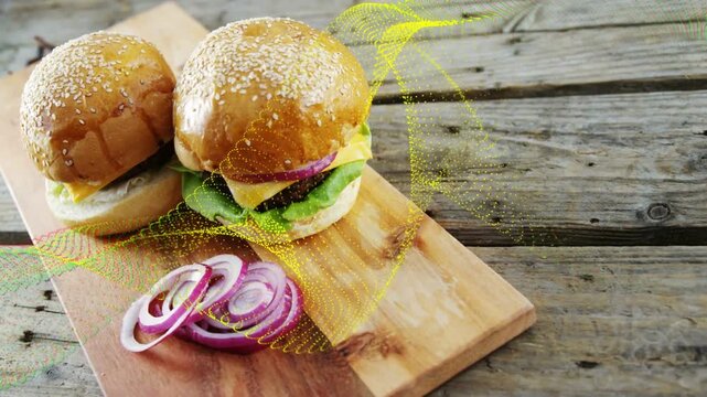 Yellow overlay sweeping from right over two burgers, camera shifting, zooming to highlight food