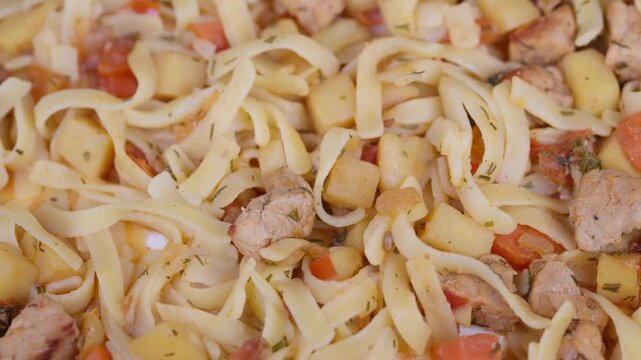 Delicious noodle dish. Hearty flat noodles with tender stew and vegetables. Appetizing image featuring braised beef noodles accompanied by colorful vegetables and seasoning