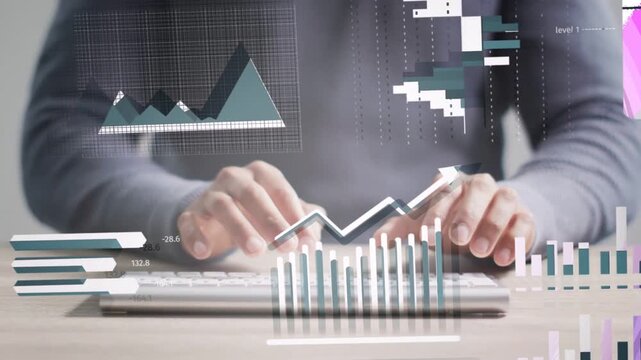 Data analyst tapping smartphone then typing at desk, animating bar charts for finance insights
