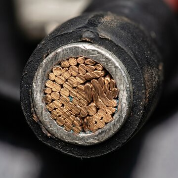 Detailed Macro Photograph Of A High-Magnification Cross-Section Of Electrical Wire Showing Copper Strands And Insulation