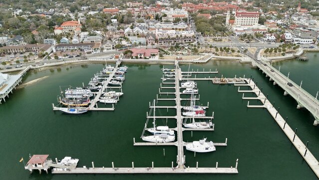 Aerial view of the St. Augustine Municipal Marina with docked sailboats and the Bridge of Lions spanning the Matanzas River in St. Augustine, Florida, United States.