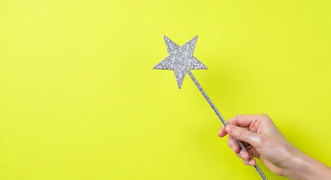 hand holding a glittery New Year star wand