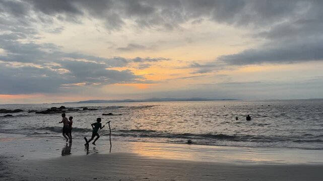 Silloute of Boys Playing Soccer on a Beach in Garabito Costa Rica at Sunset