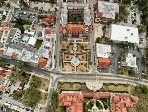 Aerial view of Flagler College featuring historic Spanish Renaissance architecture with red-tiled roofs, manicured gardens, and urban streets St. Augustine, Florida, United States.