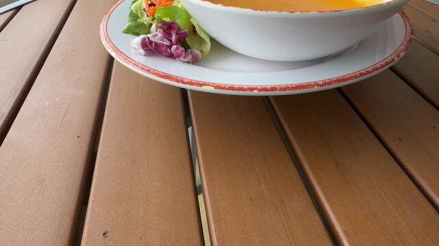 Serving. bowl of Pumpkin Soup and Salad